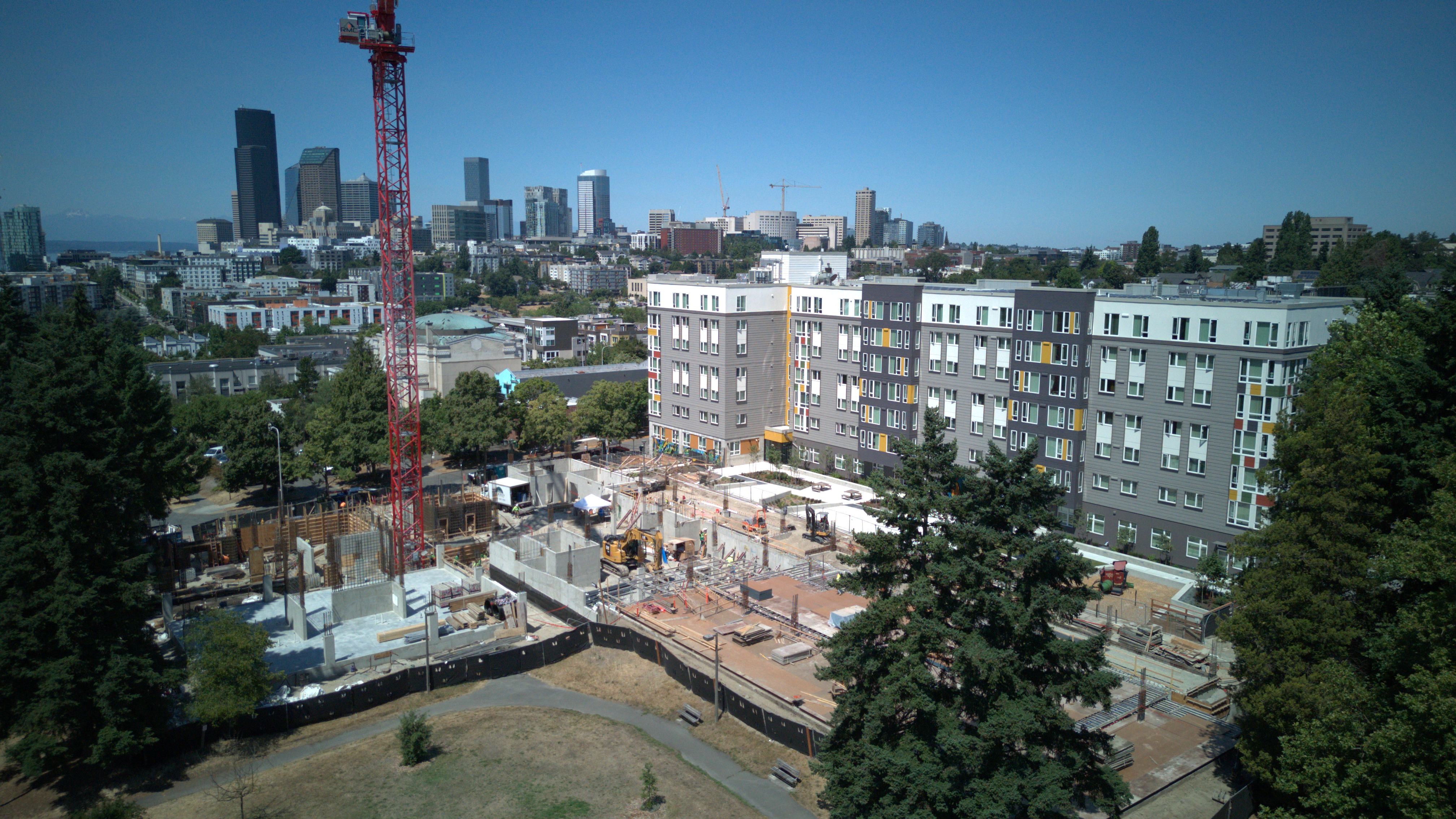 Business professionals shaking hands with construction equipment